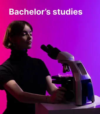 Young woman is confidently looking through microscope at her reseach sample. It represents making a choice to study at Kaunas university of technology in the Faculty of Chemical Technology.