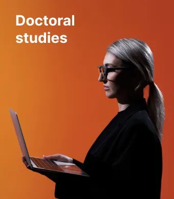 Doctoral degree studies at KTU. An expert-looking woman wearing glasses and a jacket is gazing at her laptop.